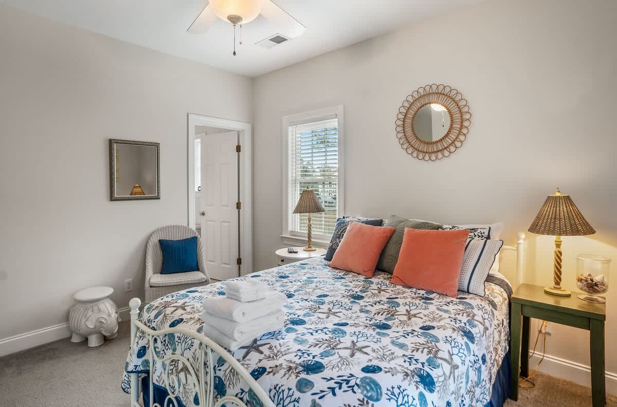 Queen Bed with Streaming TV, Private Balcony, and a Shared Jack-and-Jill Bathroom with a Shower-Tub Combo. 