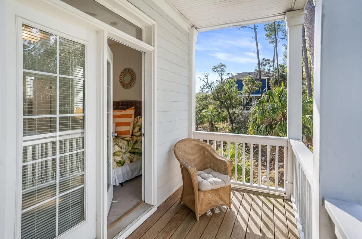 First Floor Queen Bedroom with a Streaming TV, Private Balcony, and Attached Bathroom with a Shower-Tub Combo with Convenient Hallway Access.