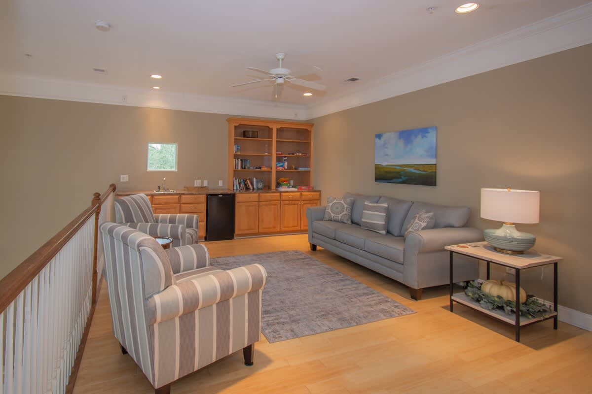 Upstairs loft with Sofa Bed, Books, and a mini Fridge