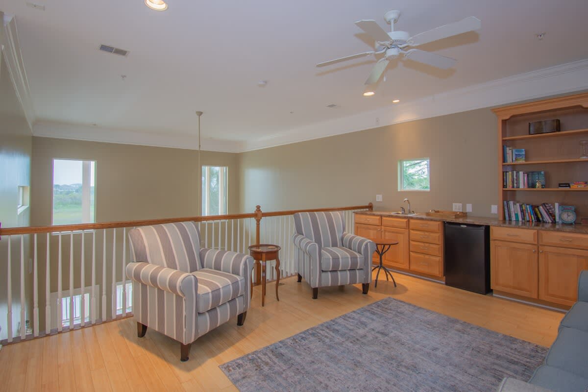 Upstairs loft with Sofa Bed, Books, and a mini Fridge