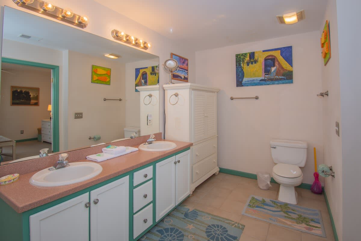 Primary bedroom with large en suite bathroom and balcony access