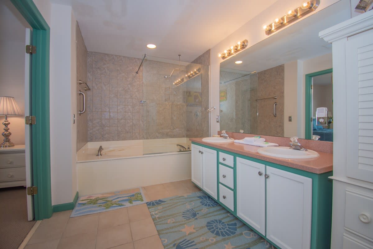 Primary bedroom with large en suite bathroom and balcony access