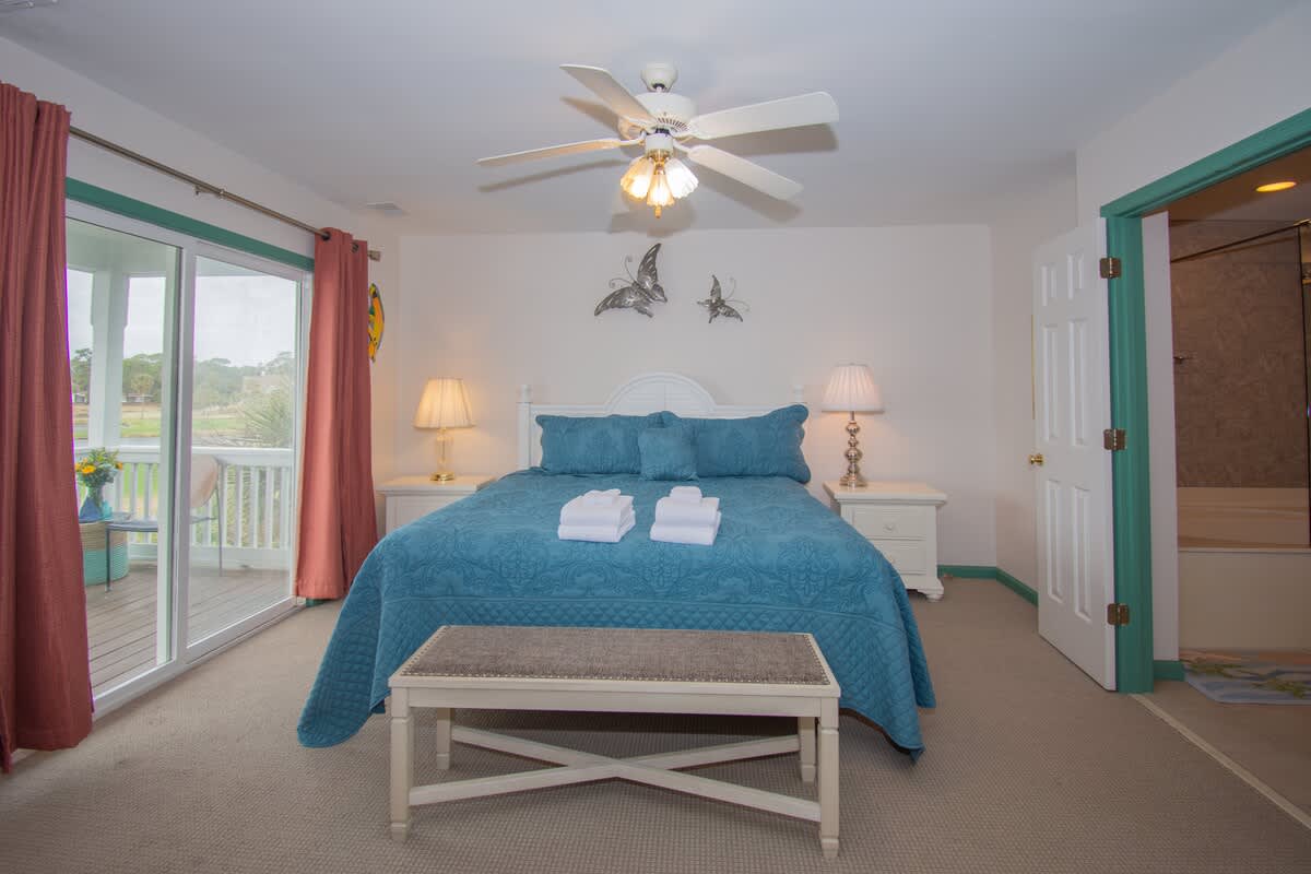 Primary bedroom with large en suite bathroom and balcony access