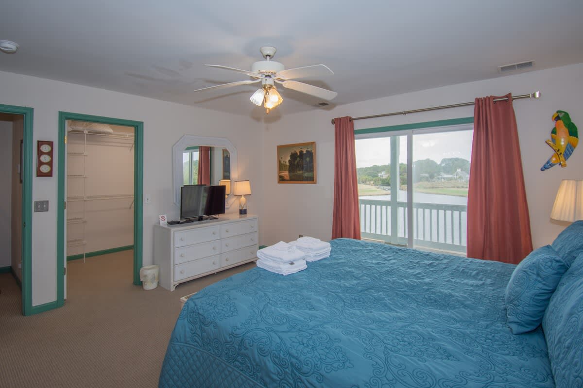 Primary bedroom with large en suite bathroom and balcony access