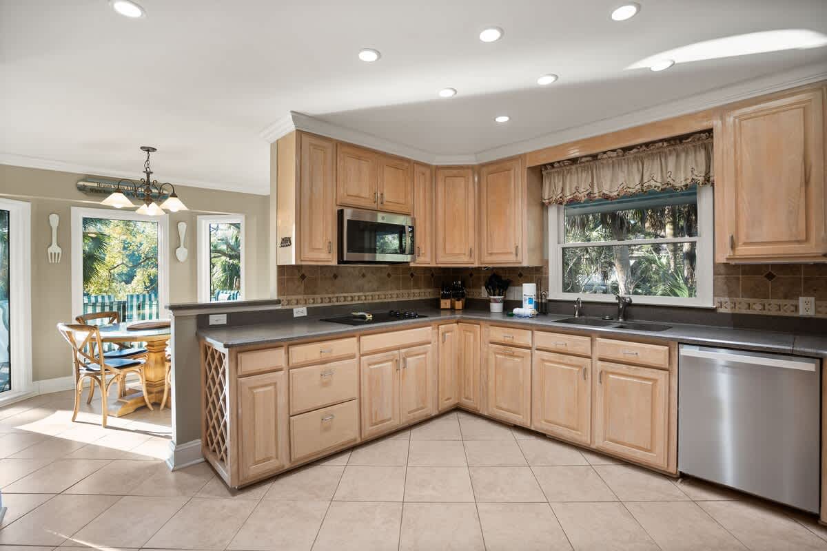  Kitchen Includes Brand-New Stainless Steel Appliances, a Coffee Machine, Kitchen Knives, and Cookware, as well as a Small Dining Table.