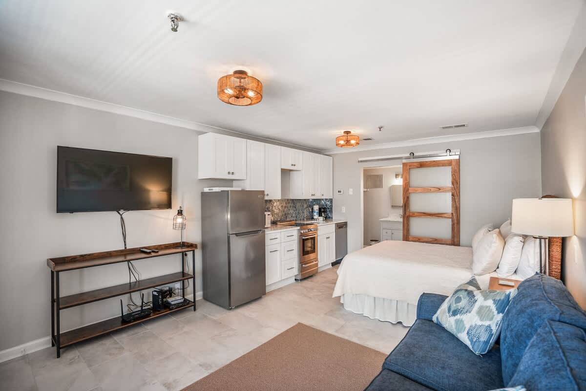 Living Room with Queen Sleeper Sofa, Queen Bed, Dining Table and Kitchen