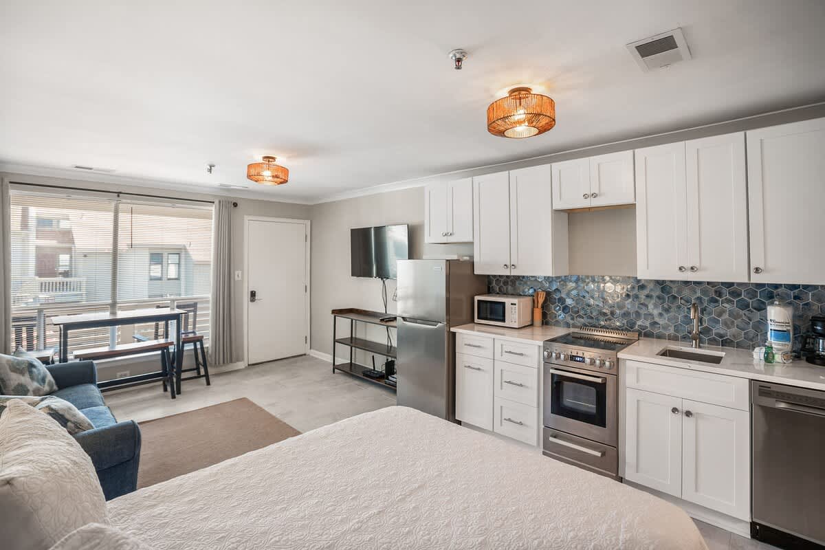 Living Room with Queen Sleeper Sofa, Queen Bed, Dining Table and Kitchen