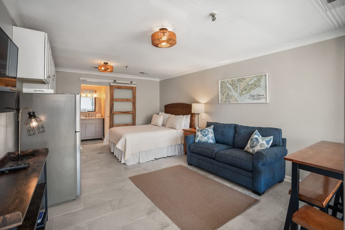 Living Room with Queen Sleeper Sofa, Queen Bed, Dining Table and Kitchen