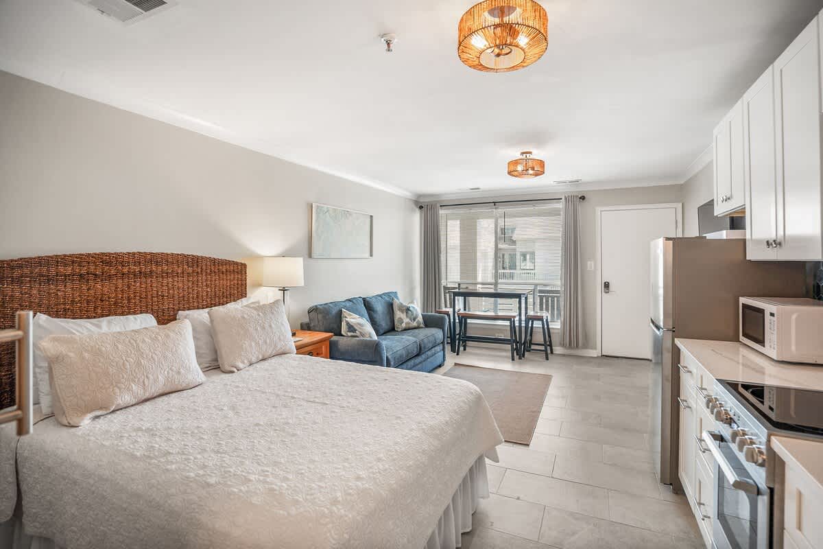 Living Room with Queen Sleeper Sofa, Queen Bed, Dining Table and Kitchen