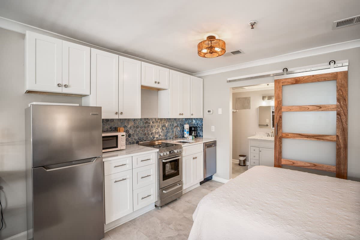 Living Room with Queen Sleeper Sofa, Queen Bed, Dining Table and Kitchen