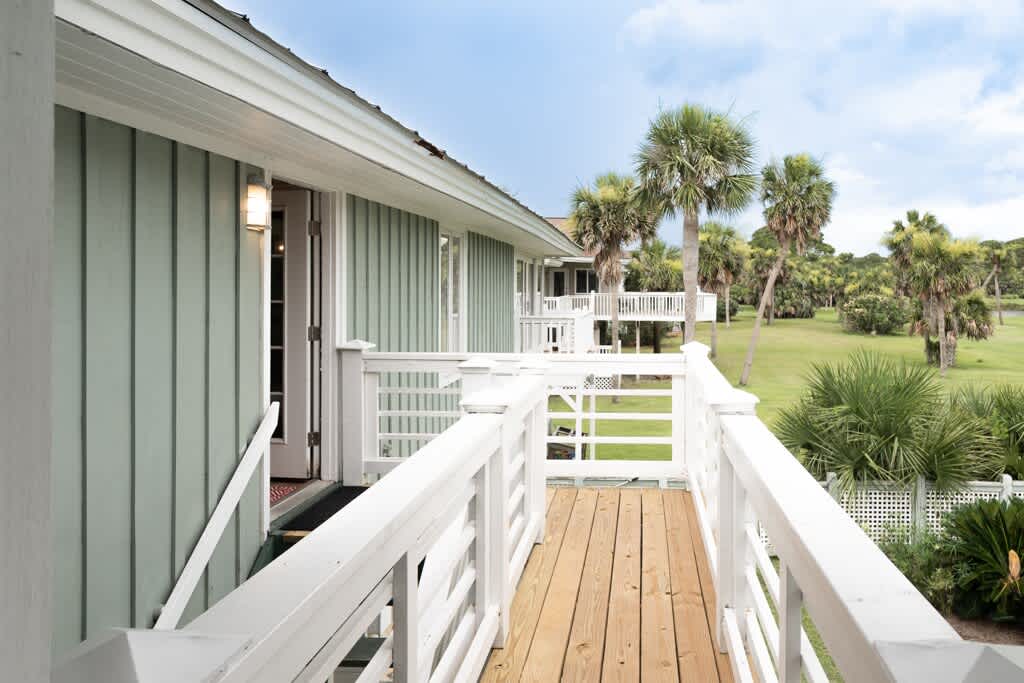 Back of the House with Staircase from Screened Porch and Kitchen to the Pool Area