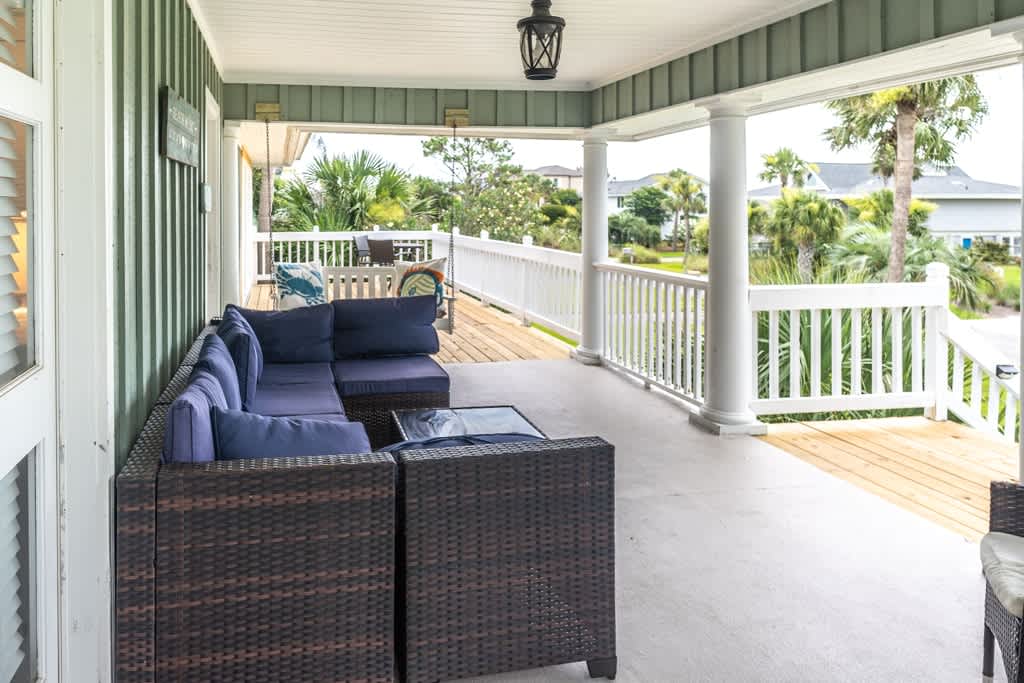 Front Door and Front Porch Area with Porch Swing and Table and Chairs off Sliding Glass Door to Living Room