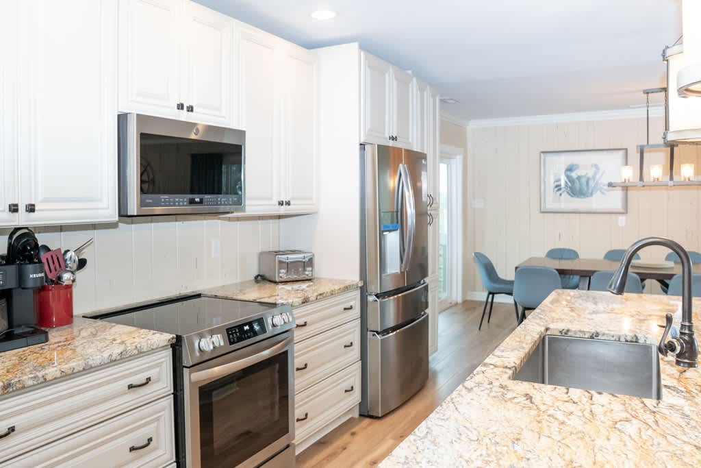 Kitchen/Island Bar and Dining Area with Access to Screened Porch