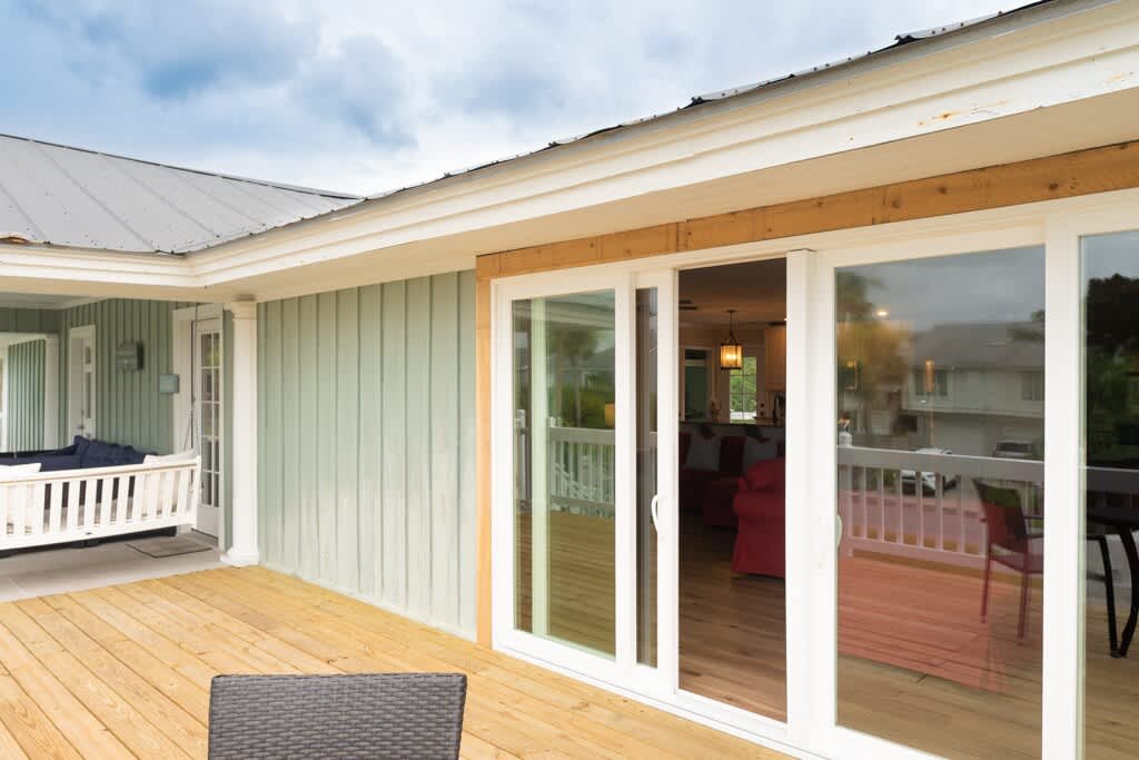 Front Door and Front Porch Area with Porch Swing and Table and Chairs off Sliding Glass Door to Living Room