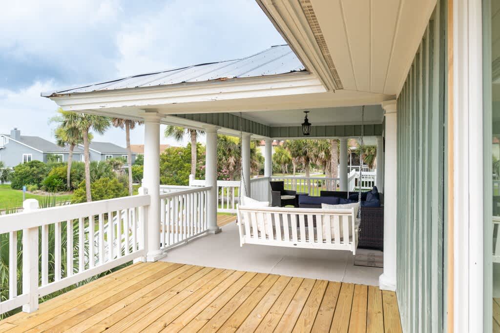 Front Door and Front Porch Area with Porch Swing and Table and Chairs off Sliding Glass Door to Living Room