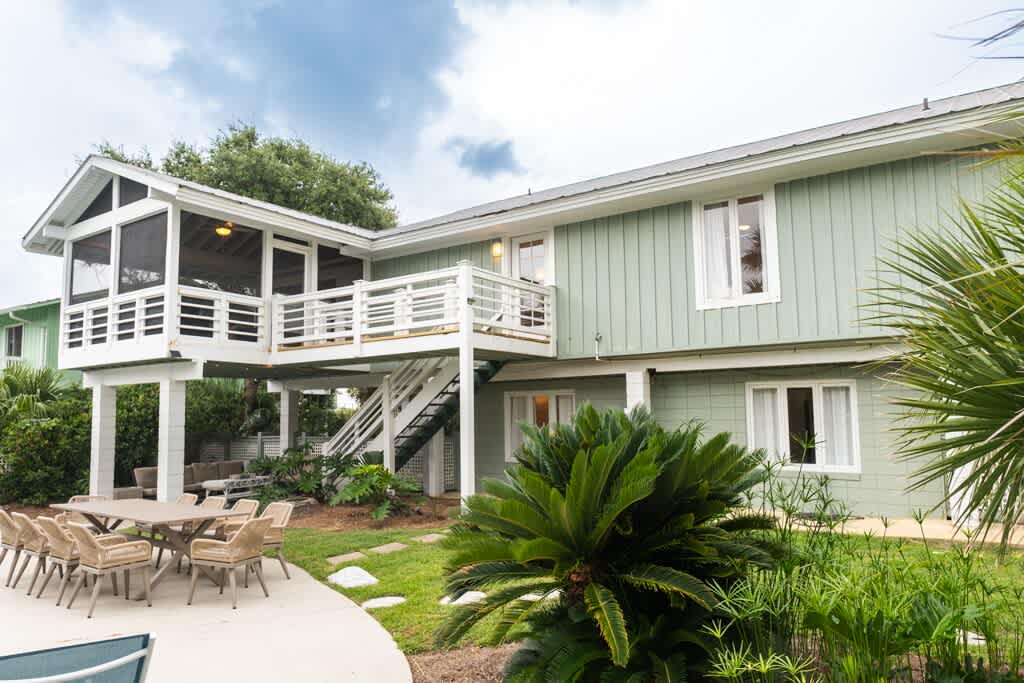 Back of the House with Staircase from Screened Porch and Kitchen to the Pool Area