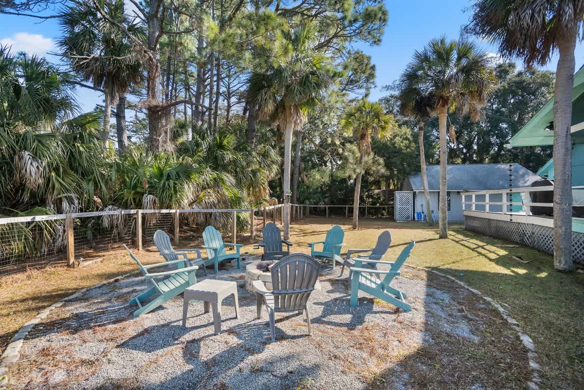 Beautiful backyard outdoor living space with water views, fenced yard and fire pit.
