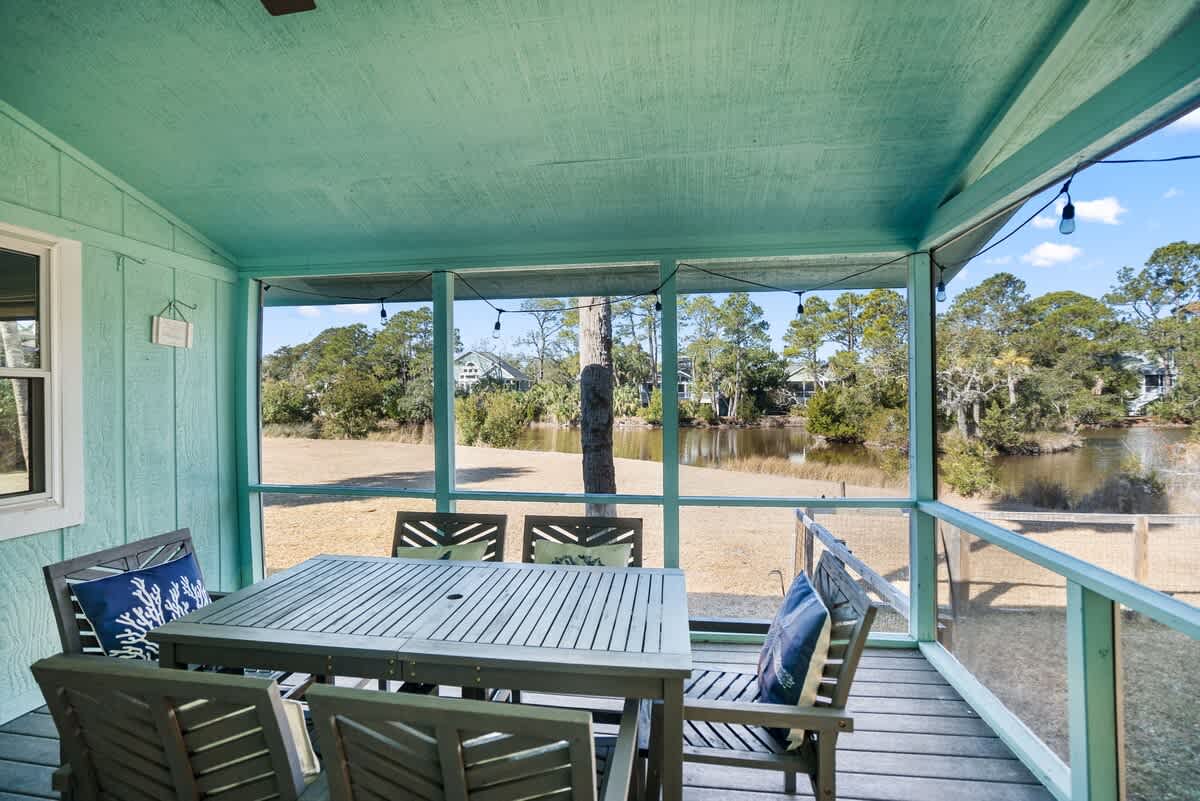 Beautiful backyard outdoor living space with water views, fenced yard and fire pit.