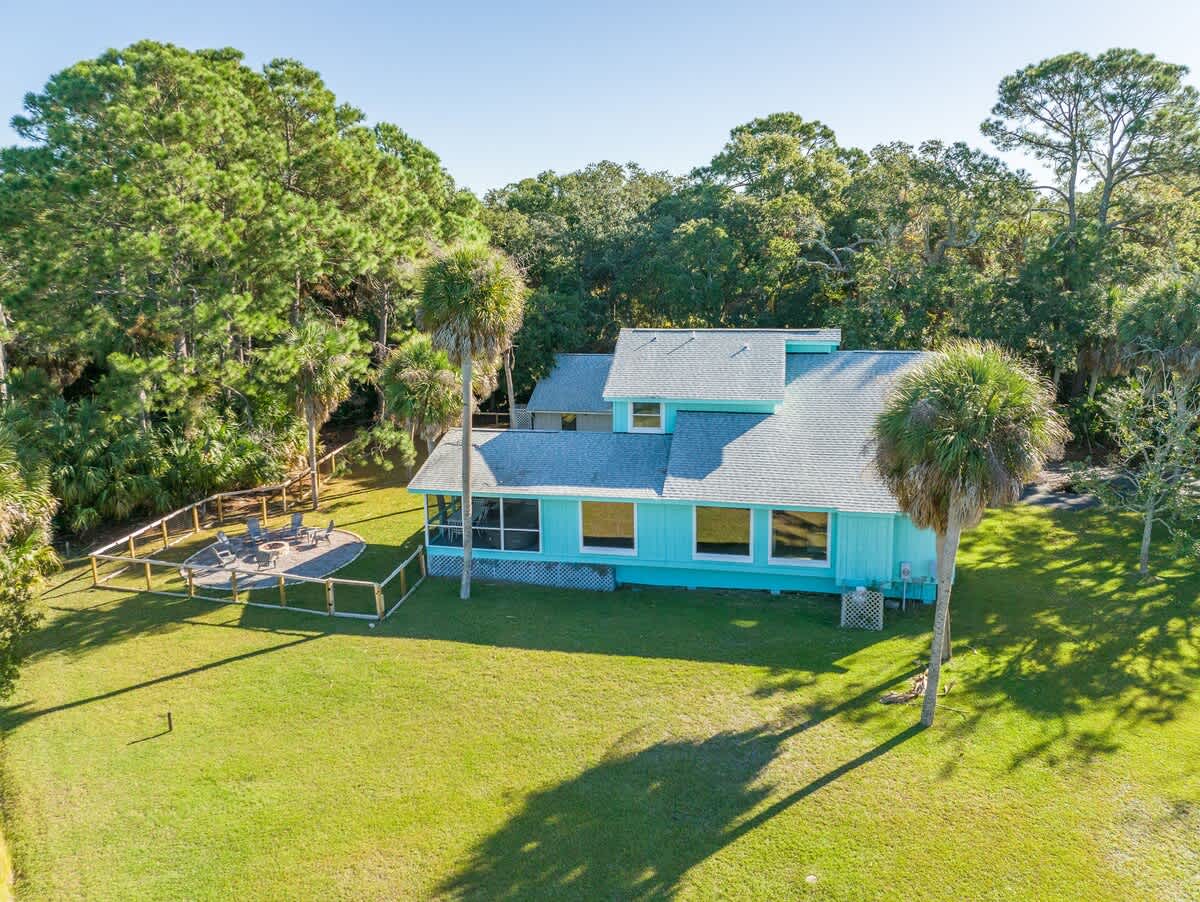 Beautiful backyard outdoor living space with water views, fenced yard and fire pit.
