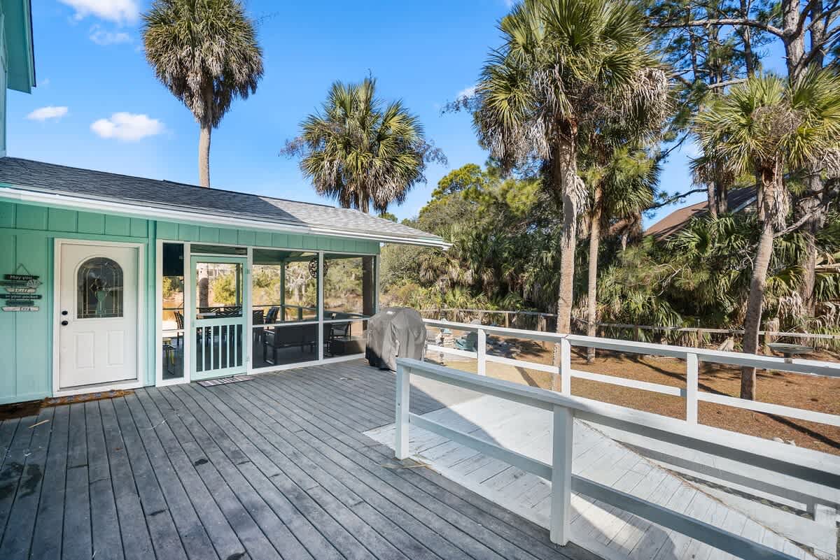 Beautiful backyard outdoor living space with water views, fenced yard and fire pit.