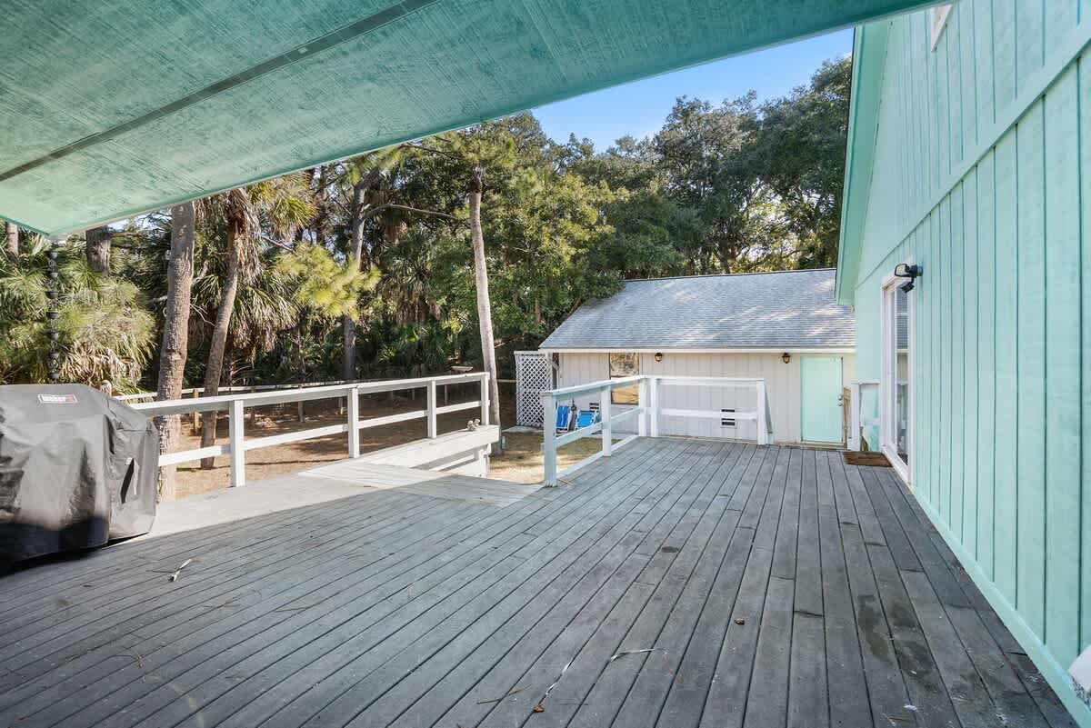 Beautiful backyard outdoor living space with water views, fenced yard and fire pit.