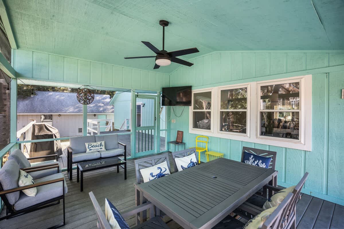 Beautiful backyard outdoor living space with water views, fenced yard and fire pit.