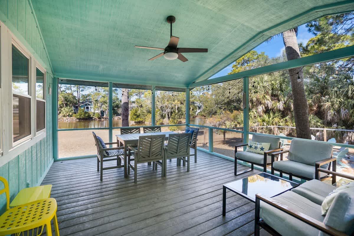 Beautiful backyard outdoor living space with water views, fenced yard and fire pit.