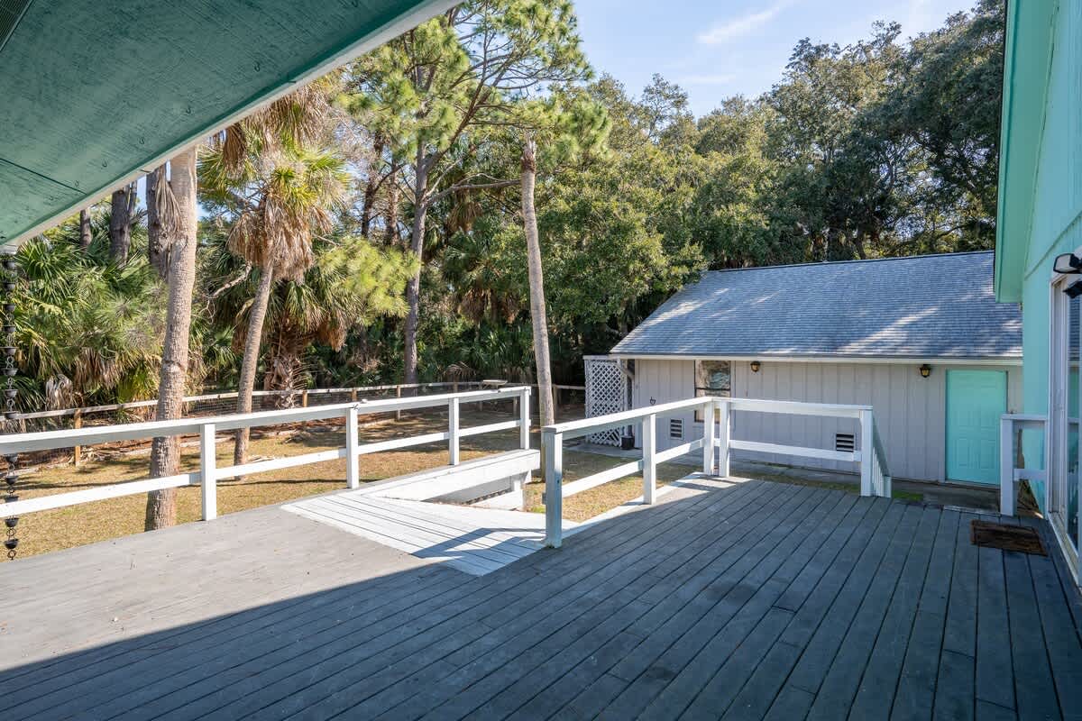Beautiful backyard outdoor living space with water views, fenced yard and fire pit.