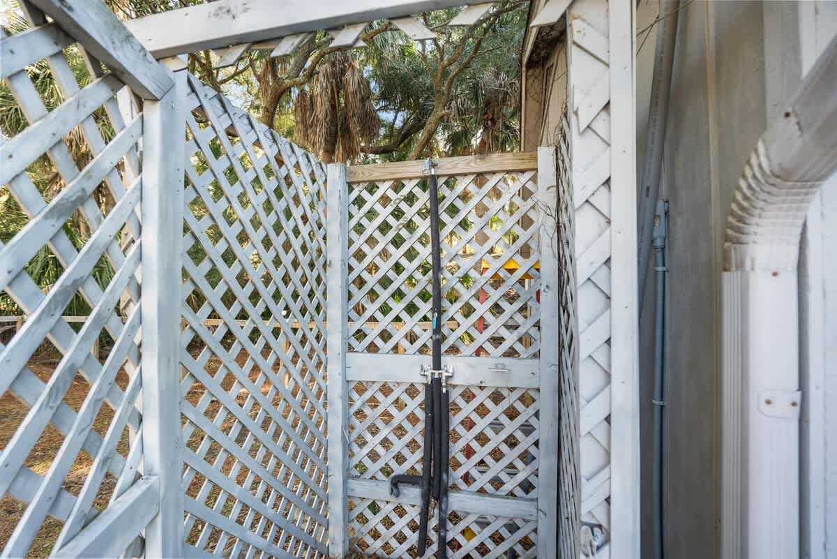 Beautiful backyard outdoor living space with water views, fenced yard and fire pit.