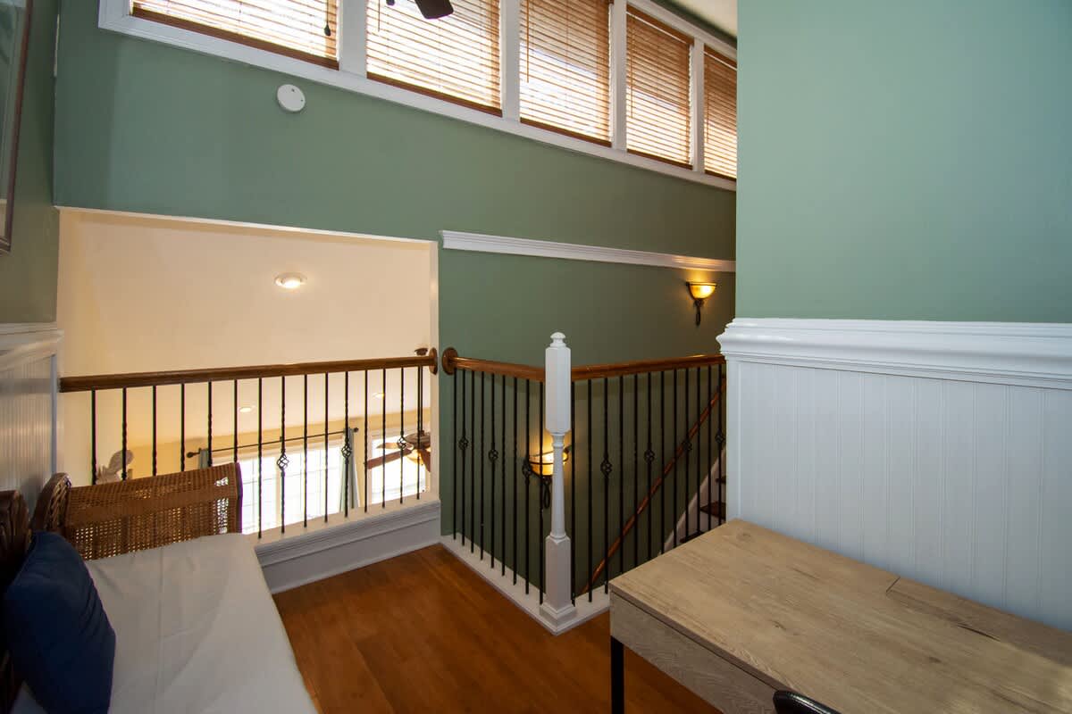 Second floor bedroom area with queen bed, trundle day bed, and en suite full bathroom.