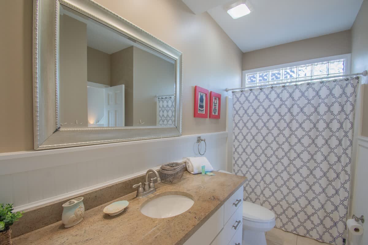 First floor guest bedroom with Jack and Jill bathroom that is shared with the hallway