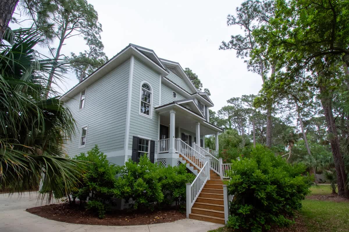 Garage, parking area and steps to front of the house.