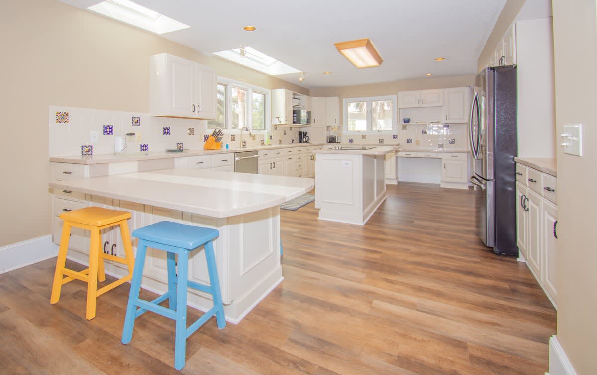 Kitchen with Updated Appliances, Including a Wall Oven and Two Islands, One With a Built-In Cooktop.