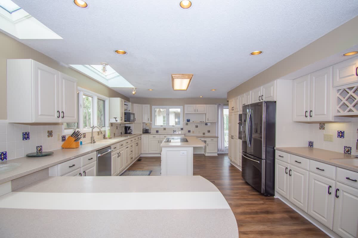 Kitchen with Updated Appliances, Including a Wall Oven and Two Islands, One With a Built-In Cooktop.