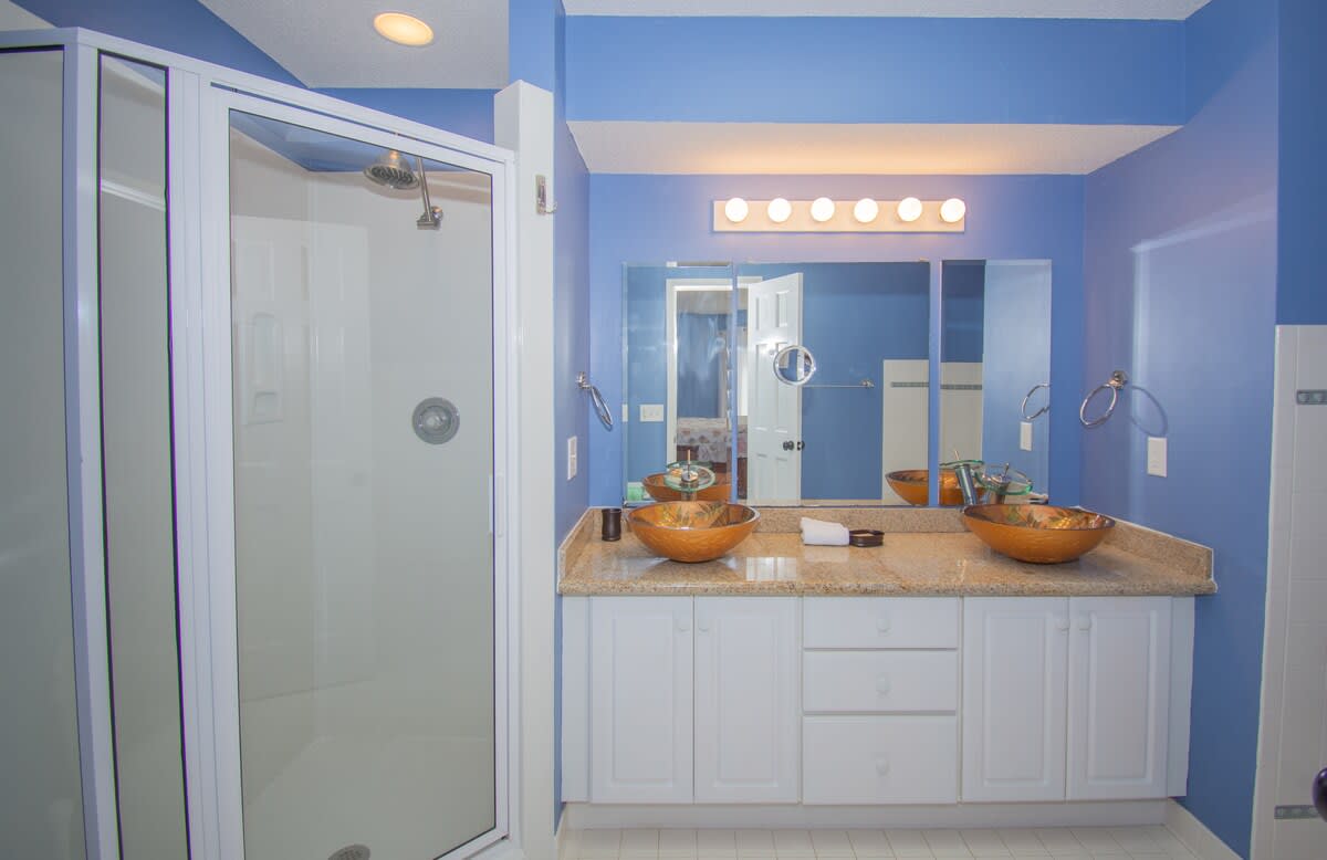 Guest Bedroom Ensuite with Double Vanity, Walk-In Shower, and Tub