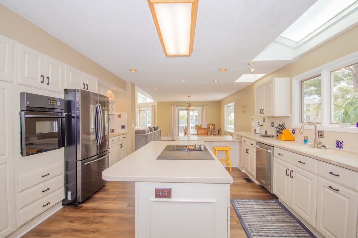 Kitchen with Updated Appliances, Including a Wall Oven and Two Islands, One With a Built-In Cooktop.
