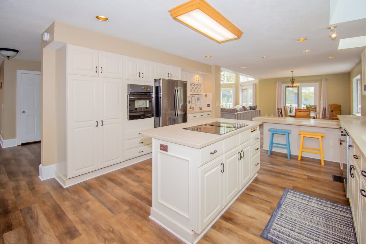 Kitchen with Updated Appliances, Including a Wall Oven and Two Islands, One With a Built-In Cooktop.