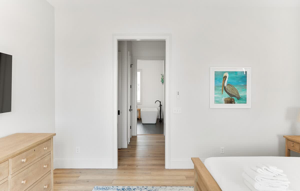 Primary Bedroom on first floor with Access to Back Deck and En-Suite 