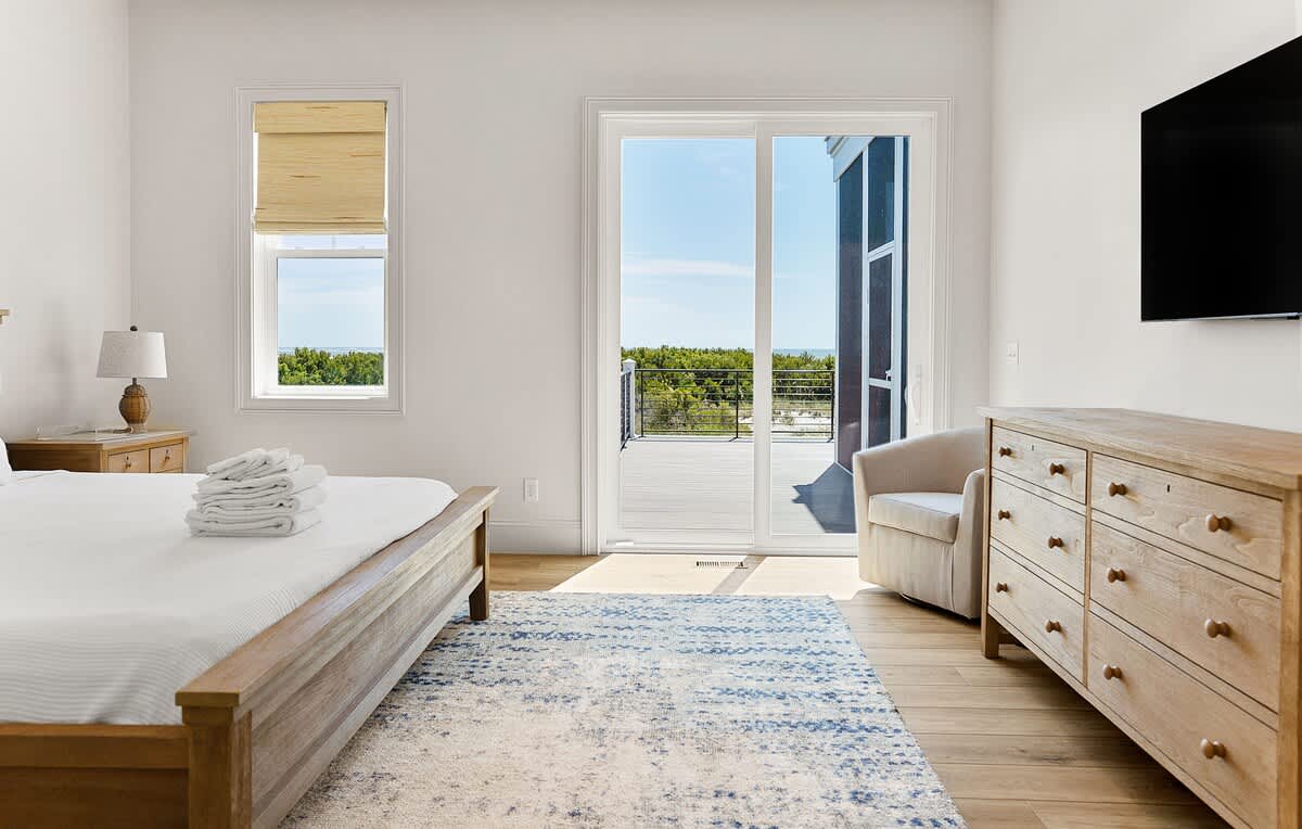 Primary Bedroom on first floor with Access to Back Deck and En-Suite 