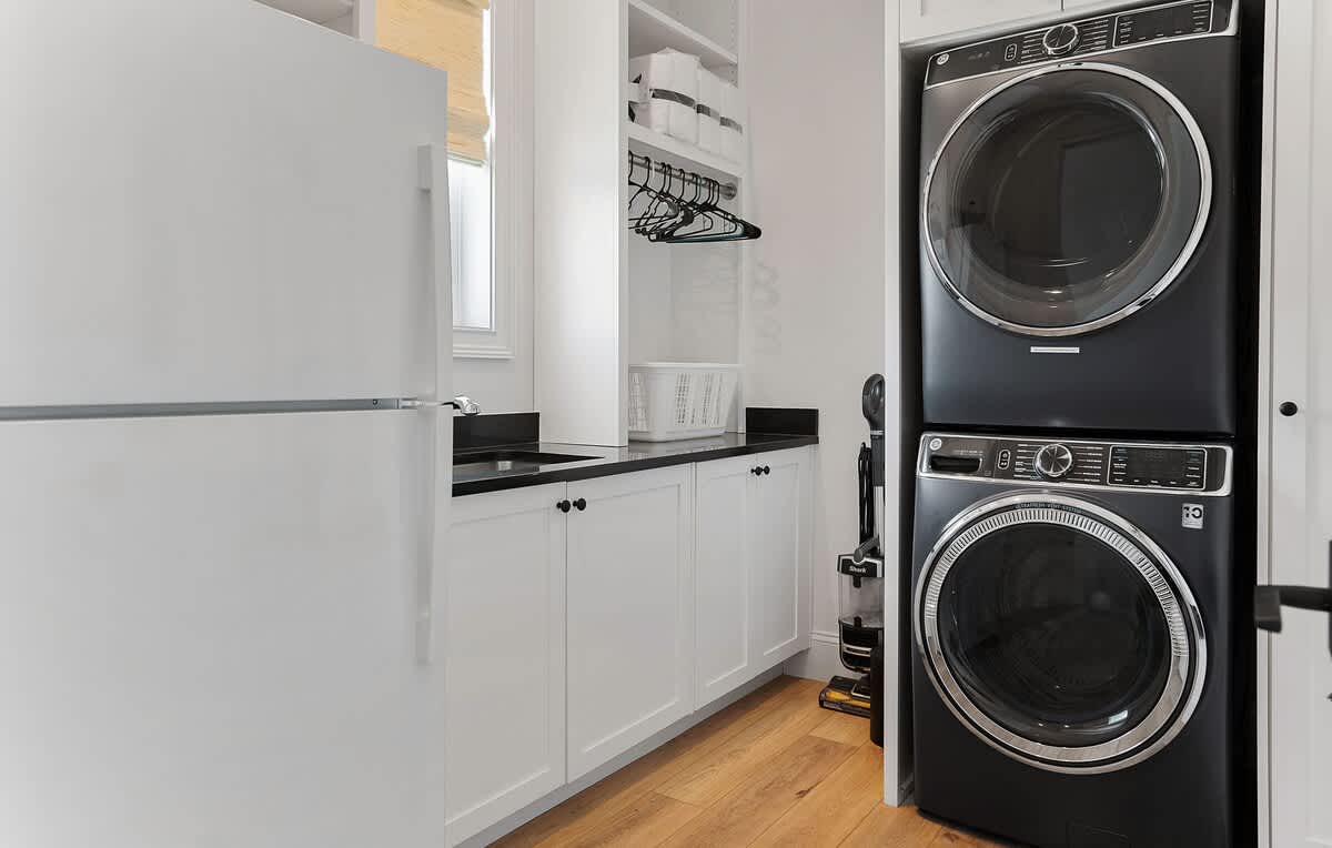 Laundry Room on First Floor with Additional Fridge and Stackable Washer and Dryer 
