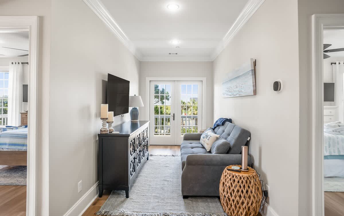 Upstairs Hallway with a Full Size Sleeper. Access out to the Second Floor Deck