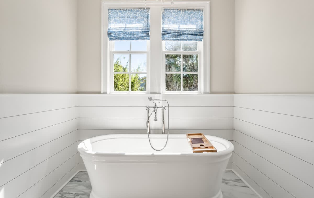 The Primary Bathroom Includes a Freestanding Tub, Double Vanity Sinks, and a Walk-In Shower