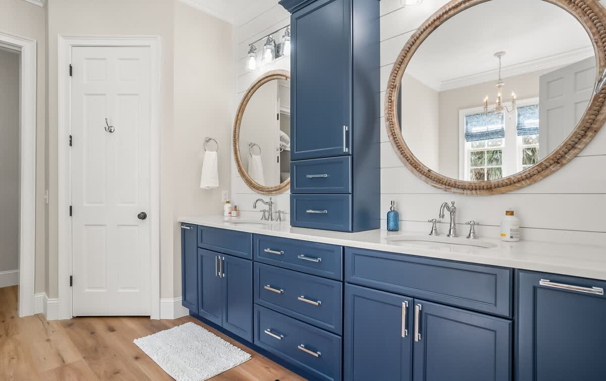 The Primary Bathroom Includes a Freestanding Tub, Double Vanity Sinks, and a Walk-In Shower
