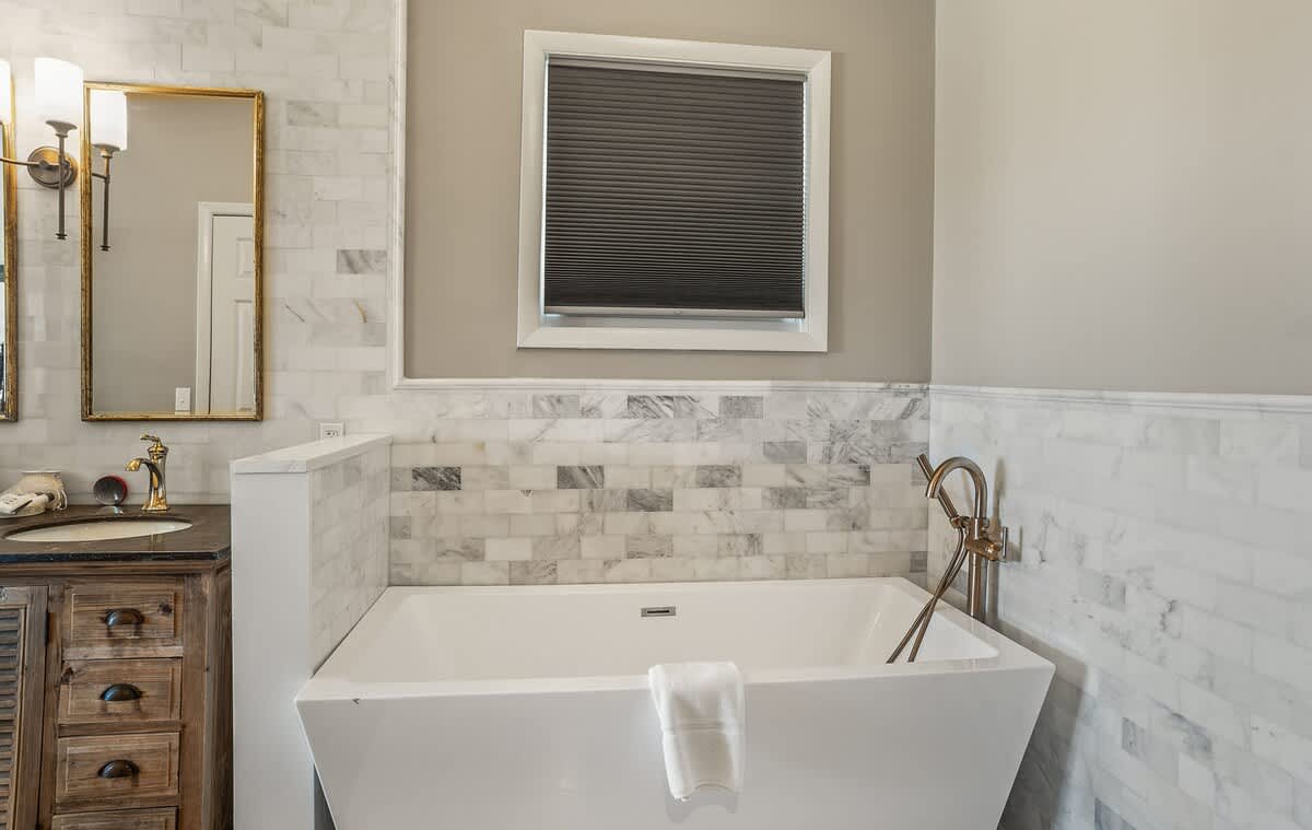 First floor primary bedroom and en suite full bathroom