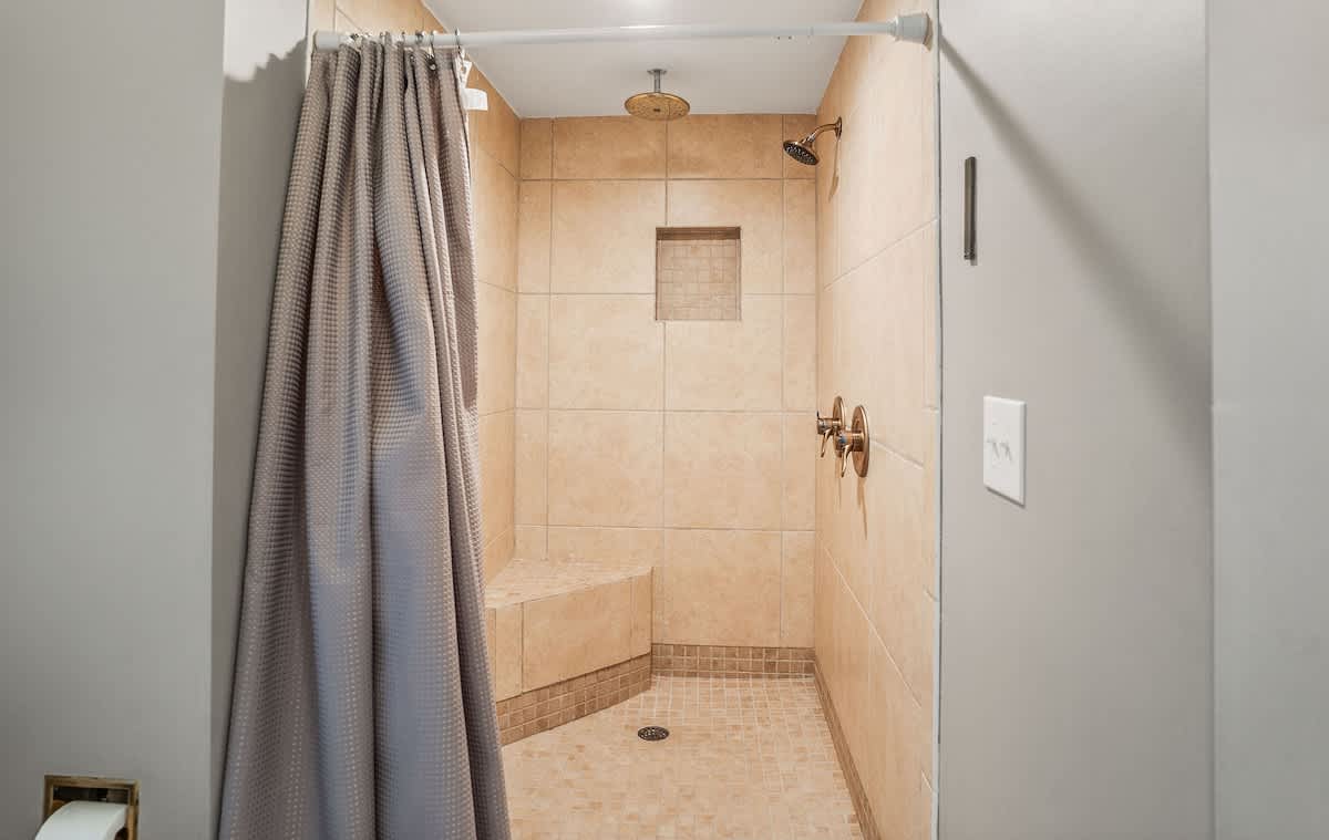 First floor primary bedroom and en suite full bathroom