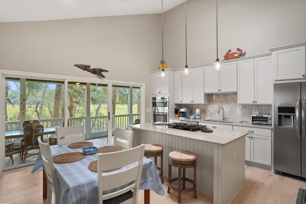 Dining Area with Kitchen Island and Access to Screened Porch