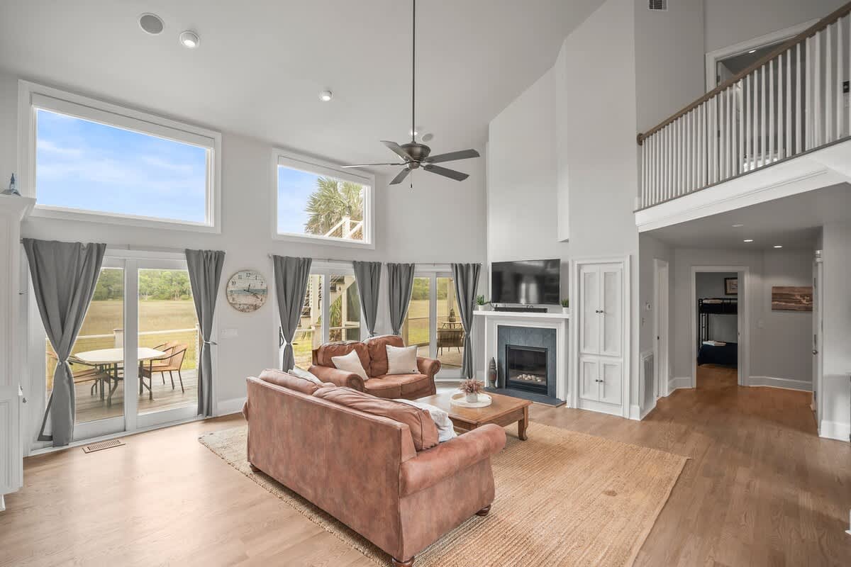 Open Concept Living Room with Access to Decks and Screened Porch with Marsh and Ocean Views