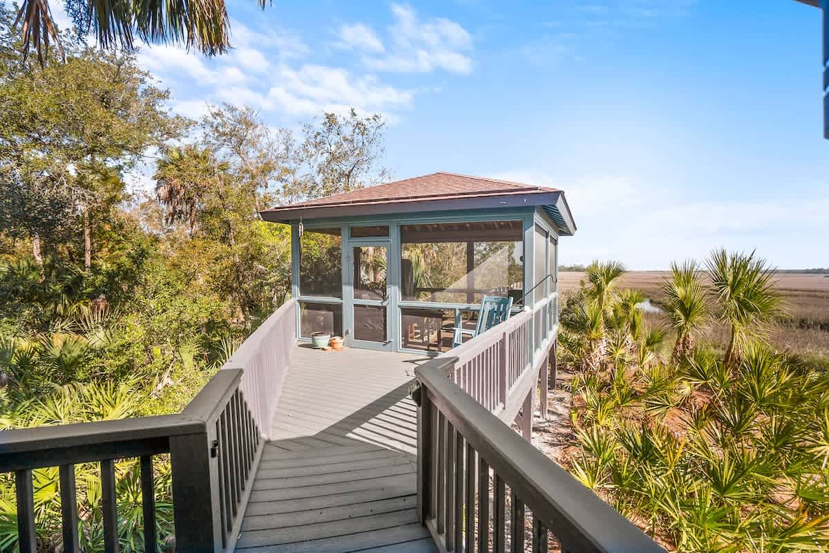 Lovely outdoor screened in living area with spectacular marsh views