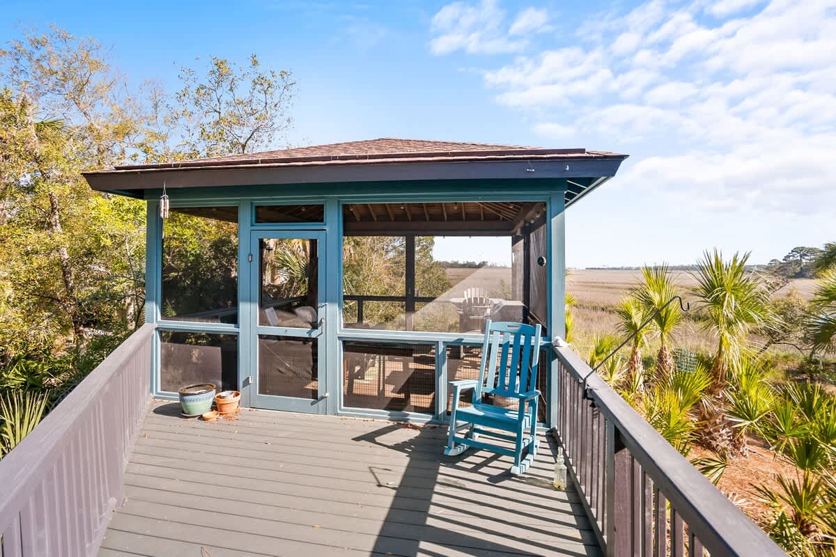 Lovely outdoor screened in living area with spectacular marsh views