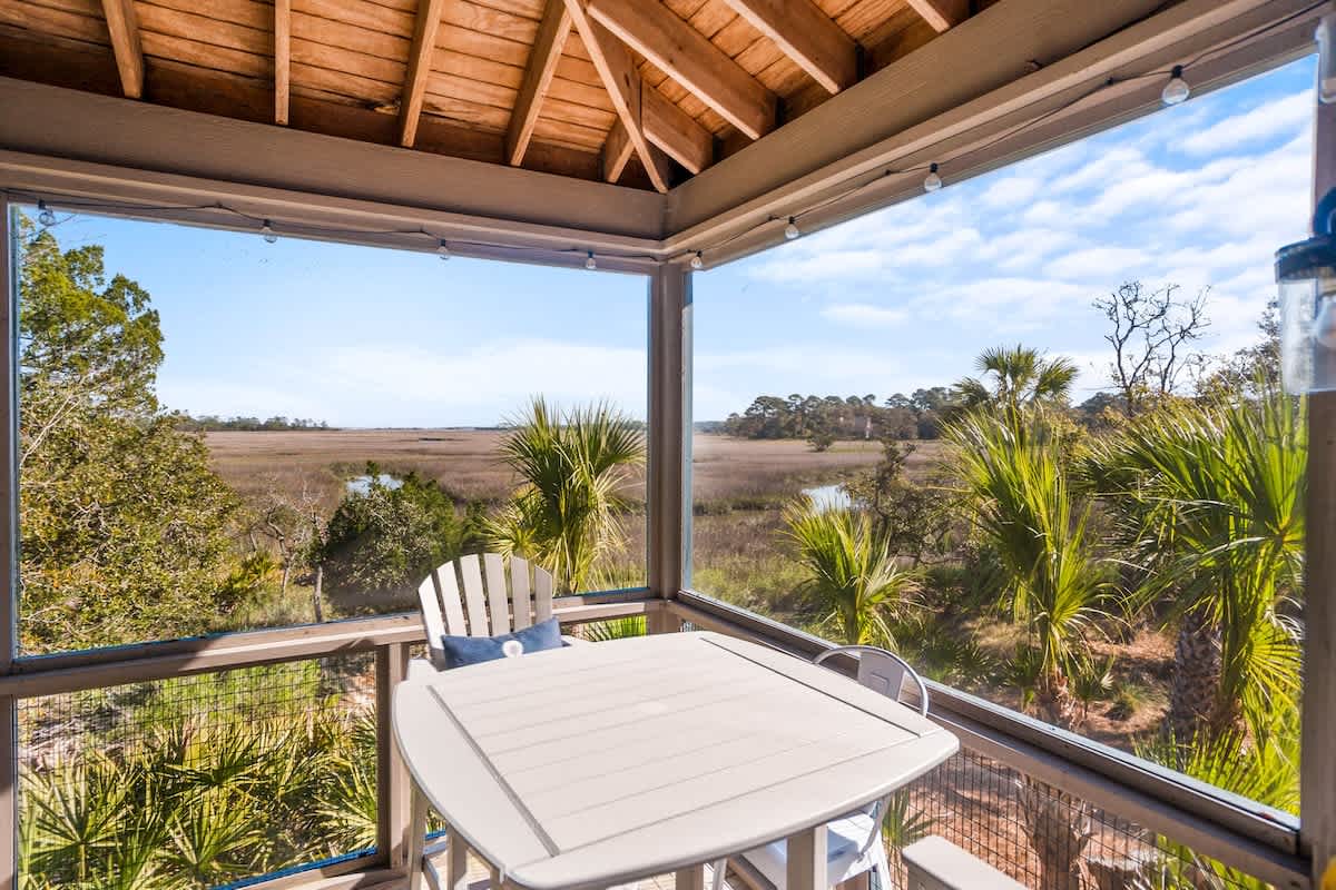 Lovely outdoor screened in living area with spectacular marsh views